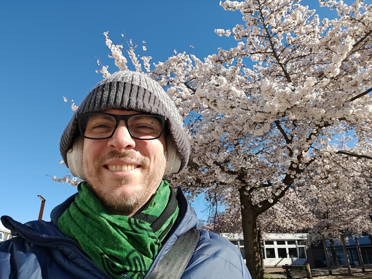 Outside with the trees.