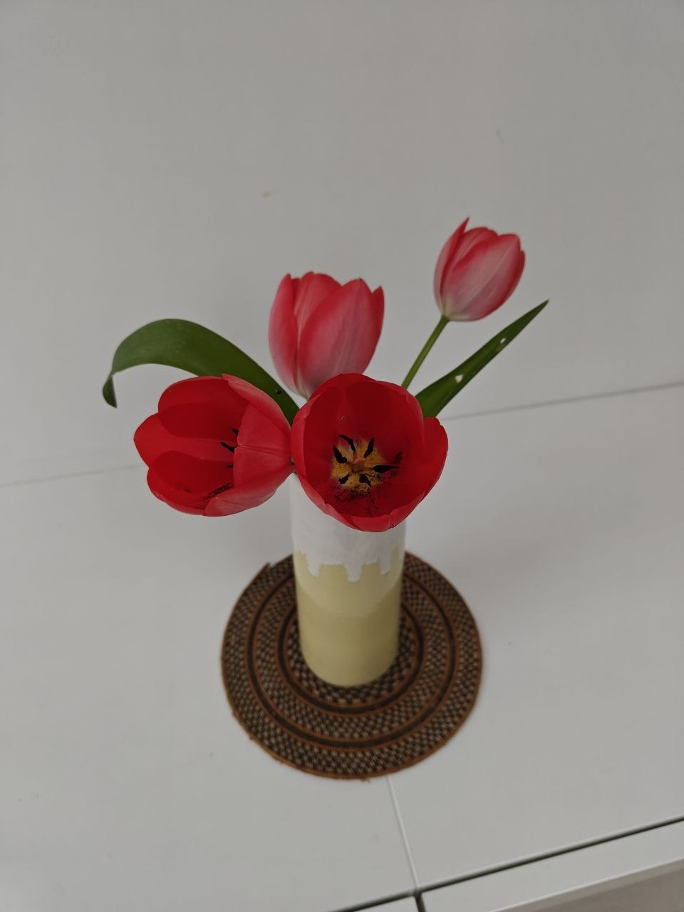 Four tulips in a vase.