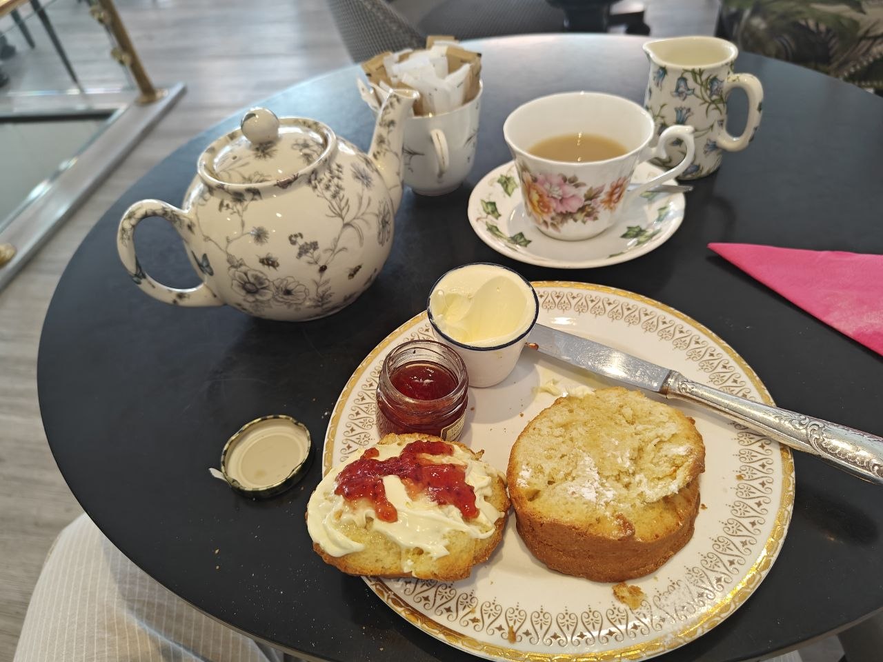 Scone, cream and jam with tea