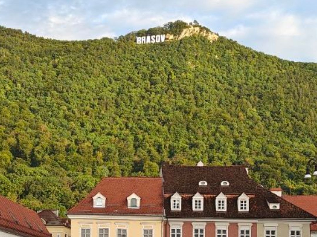 the Brașov hillside sign seen over the old town roofs